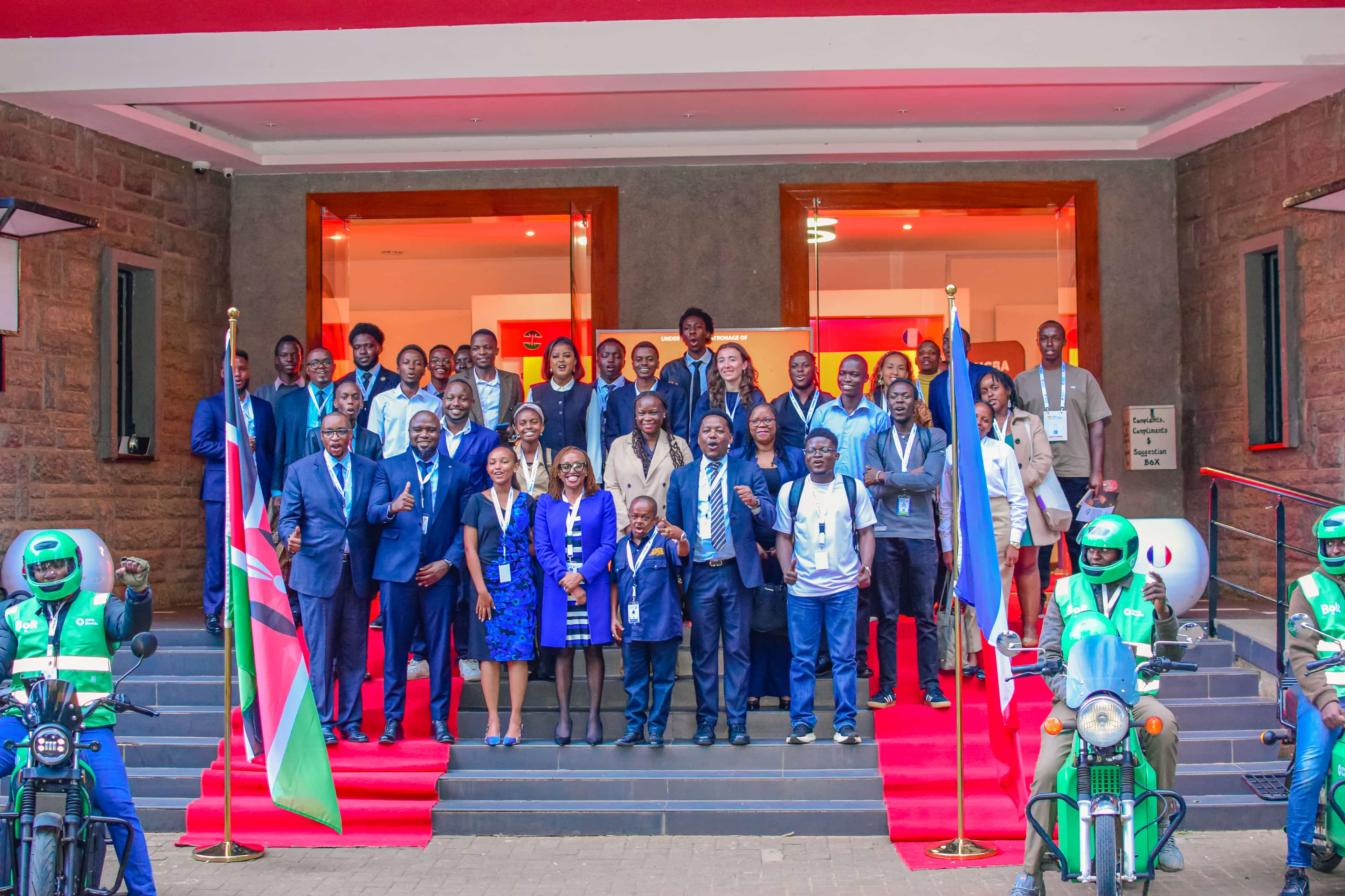 The Nova Garage 2026 group photograph on the steps of the Kenya Cultural Center, founders, conveners, and partners under the Kenyan and French flags.